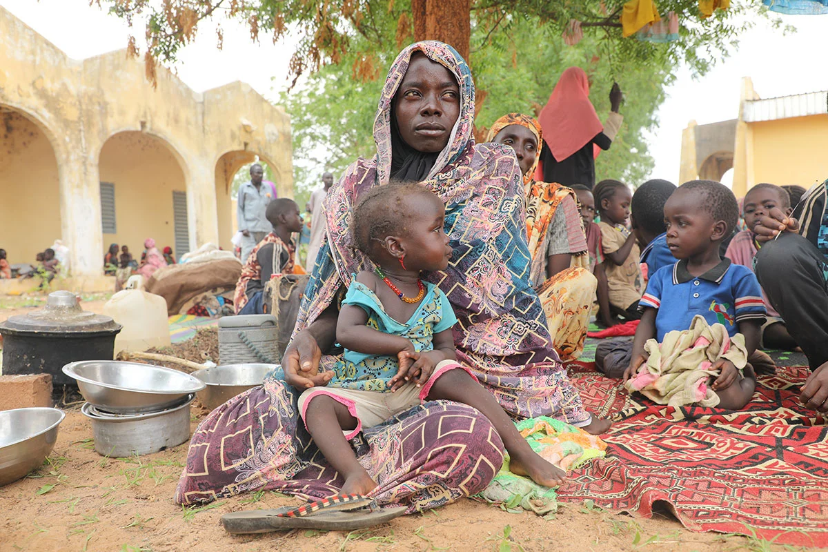sudanese woman sitting suffering